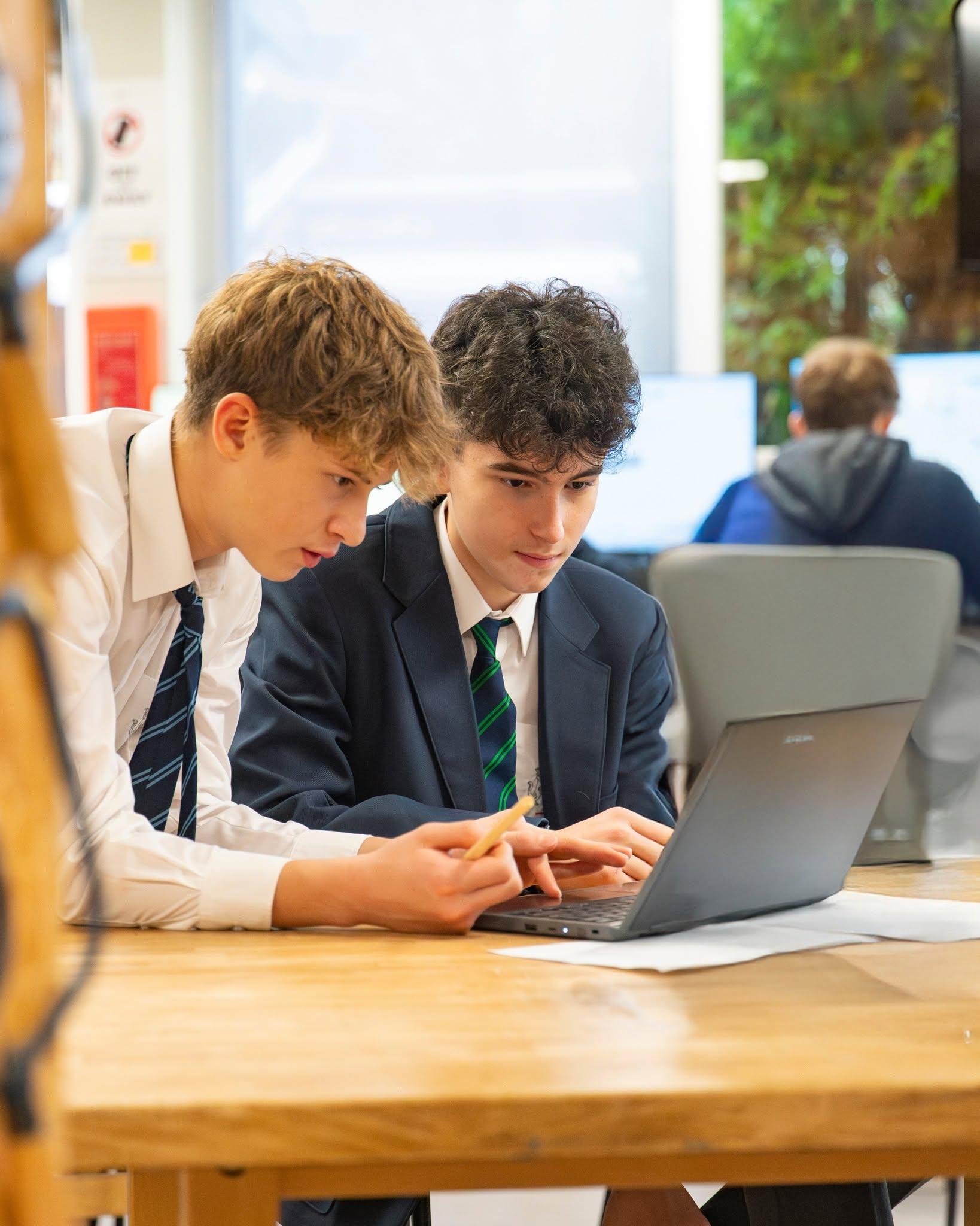 Two young people, one laptop, a problem to solve together